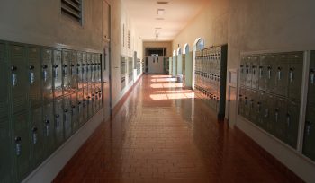 Image of empty school hallway with lockers along the walls