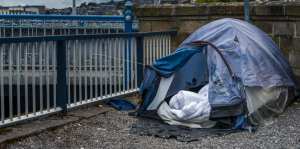 Tent next to a bridge belonging to an individual experiencing homelessness