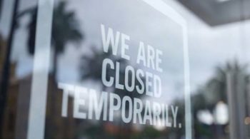 Door with sign saying "we are closed temporarily"
