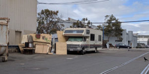 Trailer next to cardboard boxes belonging to an individual experiencing homelessness