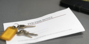 Paper of eviction notice with set of keys on top