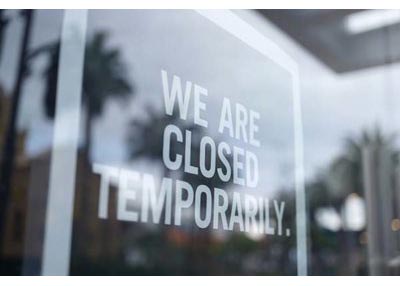 Door with sign saying "we are closed temporarily"