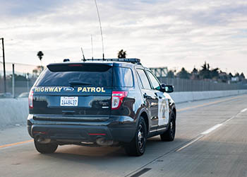 CA Highway Patrol vehicle driving on a highway