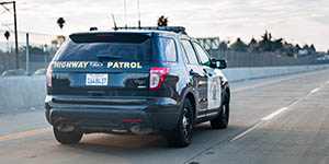 Highway patrol car driving on the freeway
