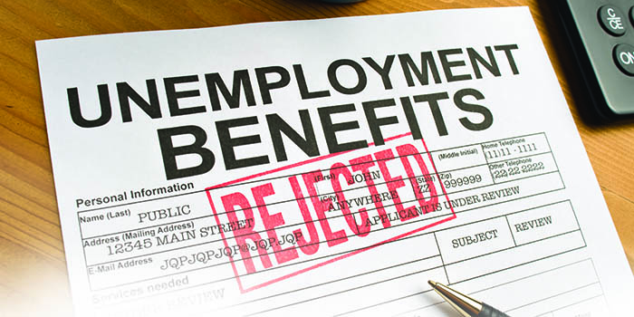 Image is a paper unemployment benefits application form, with a large red "REJECTED" stamped across it.