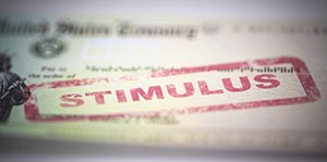 Image of a stimulus check. STIMULUS is stamped in red ink on the top.