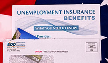 Image of an envelope from the Employment Development Dept, containing an Electronic Benefits Transfer card and a brochure about unemployment insurance benefits, all of which is sitting on an American flag.